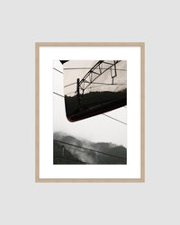 Framed landscape photograph of a mountainscape against a light gray background
