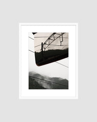 Framed landscape photograph of a traintracks with a mountainous landscape.