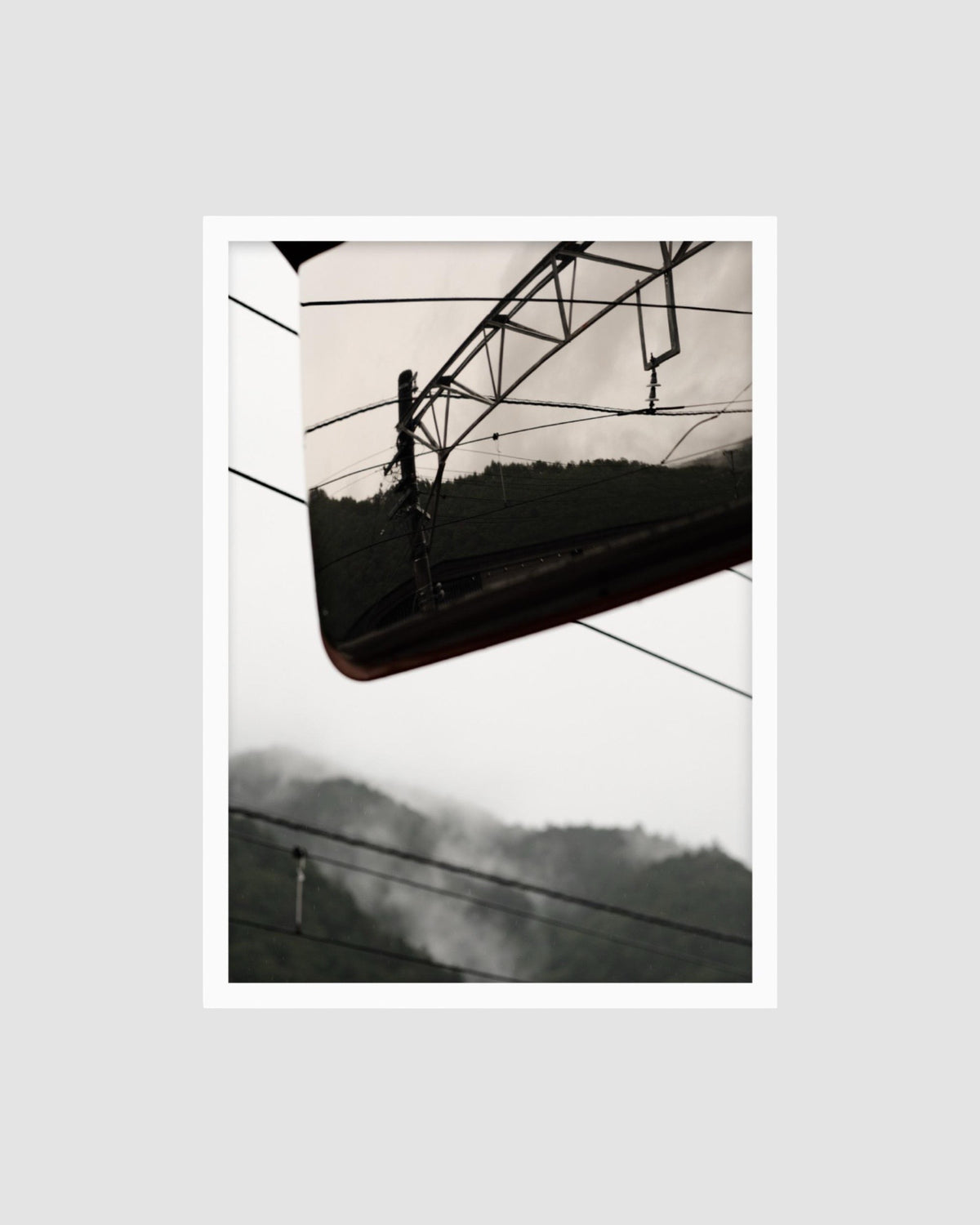 photograph of power lines with a mountainous background