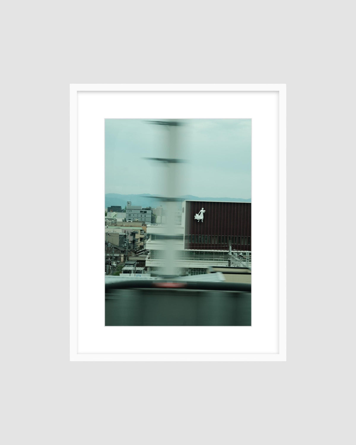 Framed photograph of a cityscape with a blurred effect on a light gray background