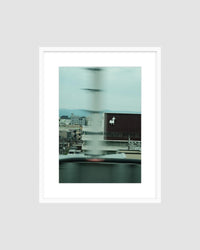 Framed photograph of a cityscape with a blurred effect on a light gray background