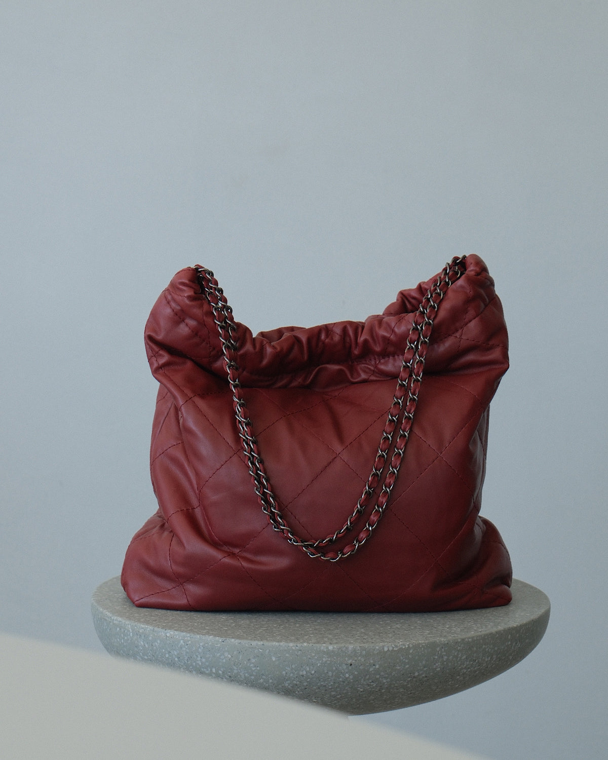 Quilted burgundy carryall with chain shoulder strap