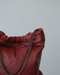 Quilted burgundy carryall with chain shoulder strap