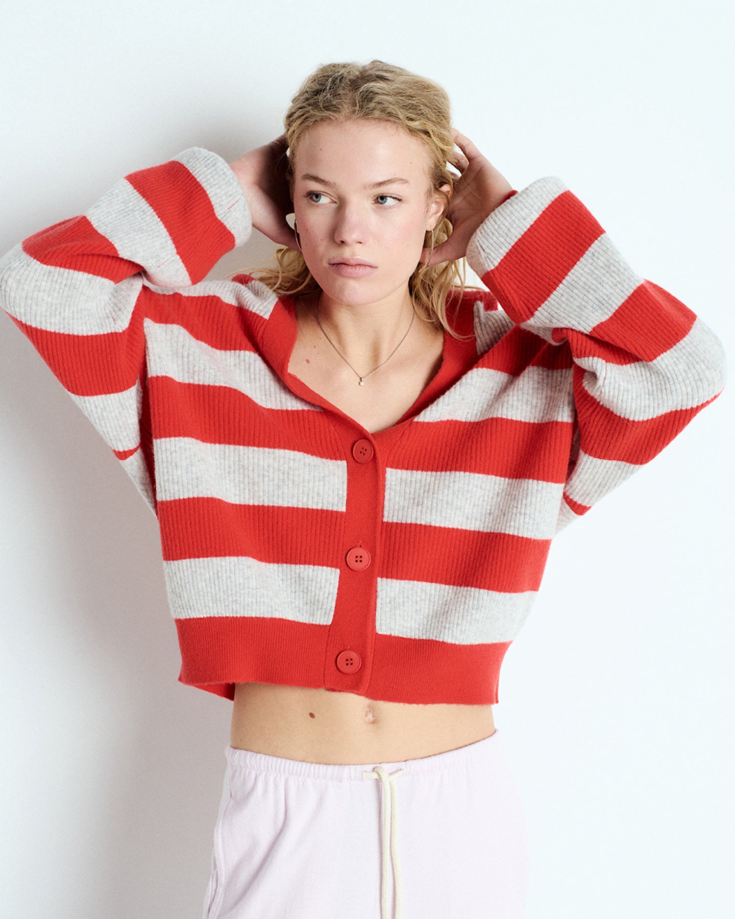 model wears a red & grey stripe oversized cardigan