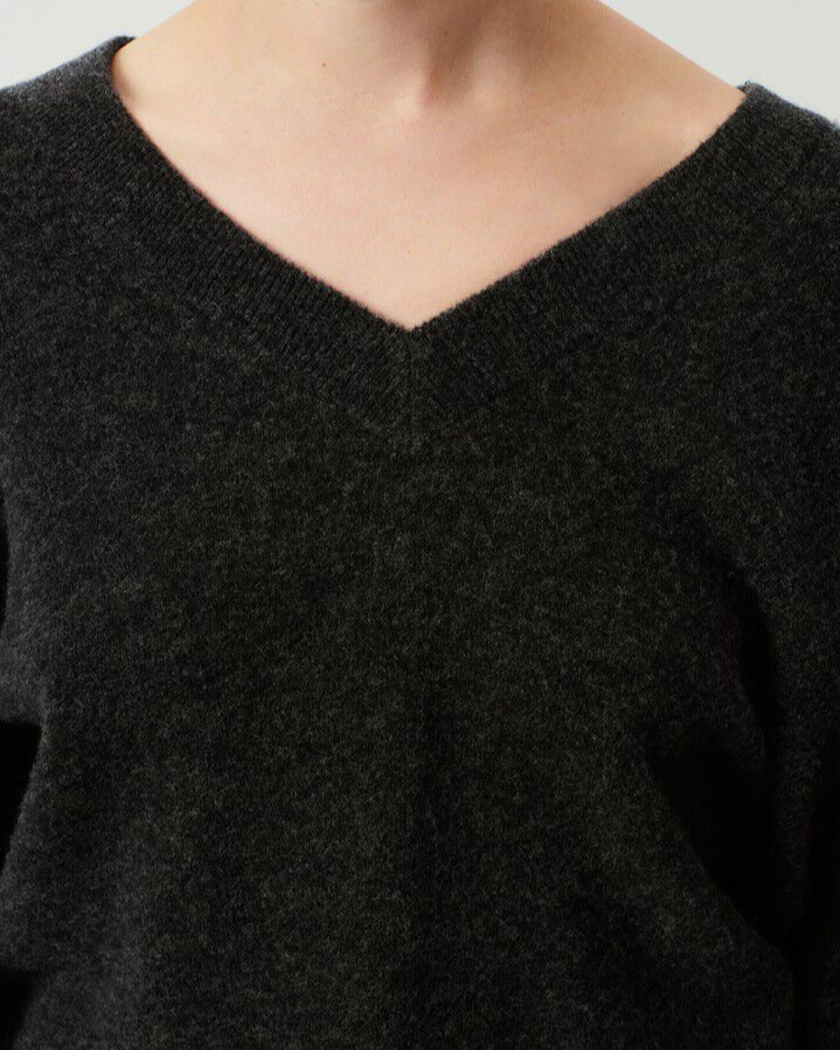 Model wears a charcoal Razow Sweater in charcoal