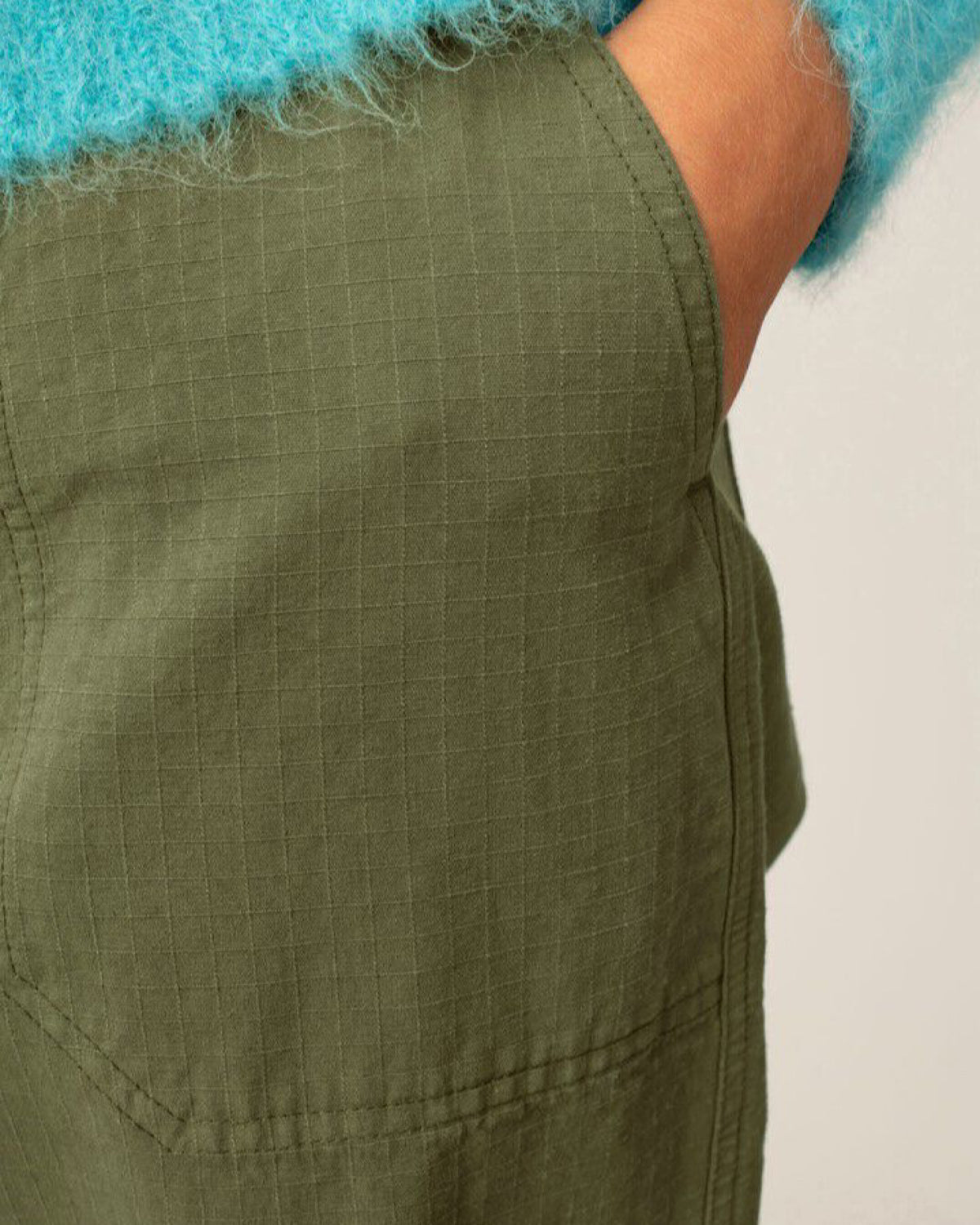 Green pants with a textured pattern on a plain background