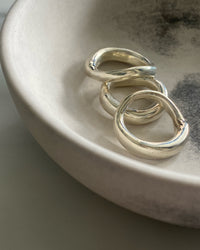 Three silver organic silver rings by Johnny Ramli sit in a bowl, Available at The Pared Store, Surry Hills