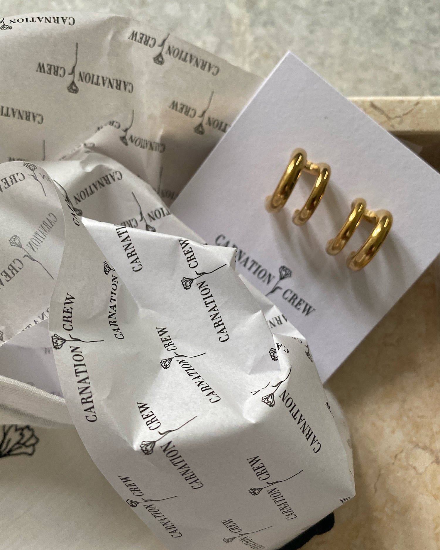 Sigourney double hoop gold earrings packaged