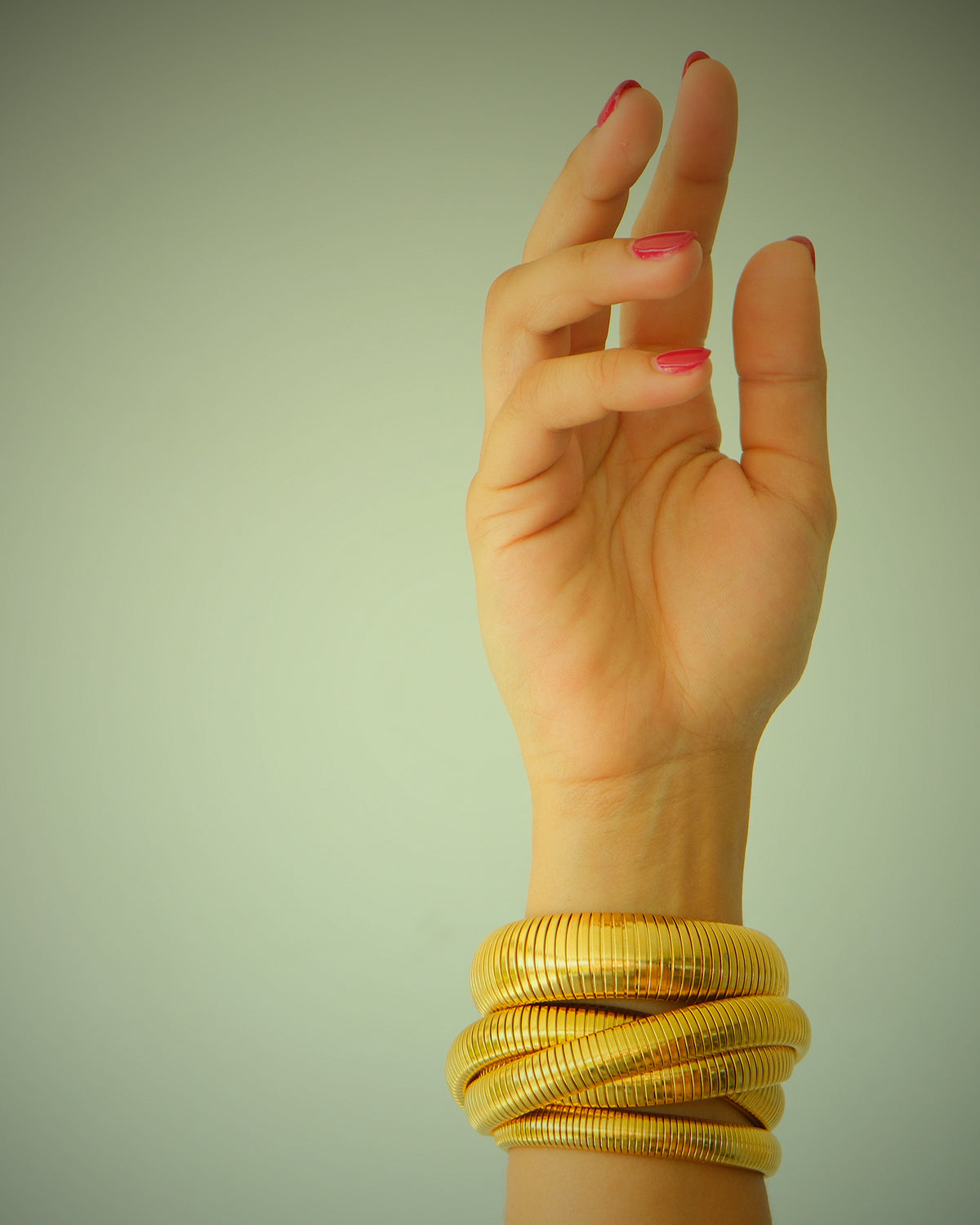 MOdel wears three snake gold bangles