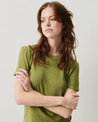 Model wears an American  Vintage Sonoma round neck T-shirt in Cameleon green