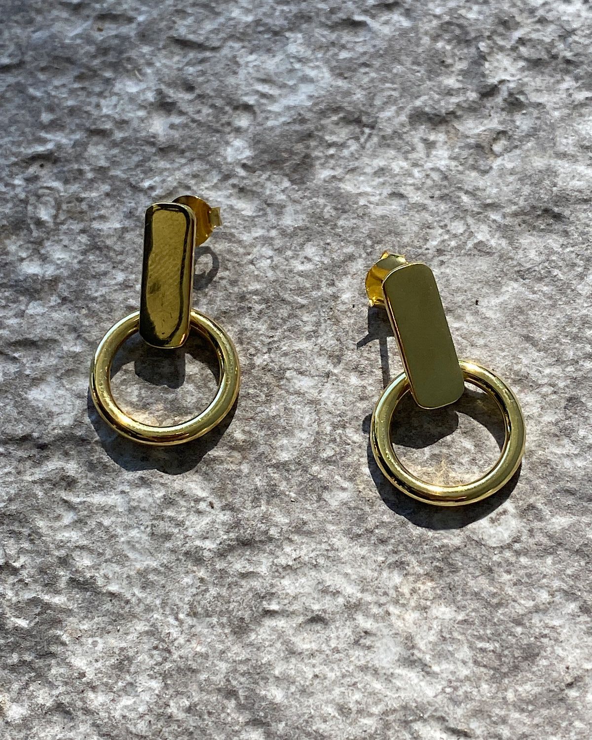 Gold rectangular studs with open hoops handing from them