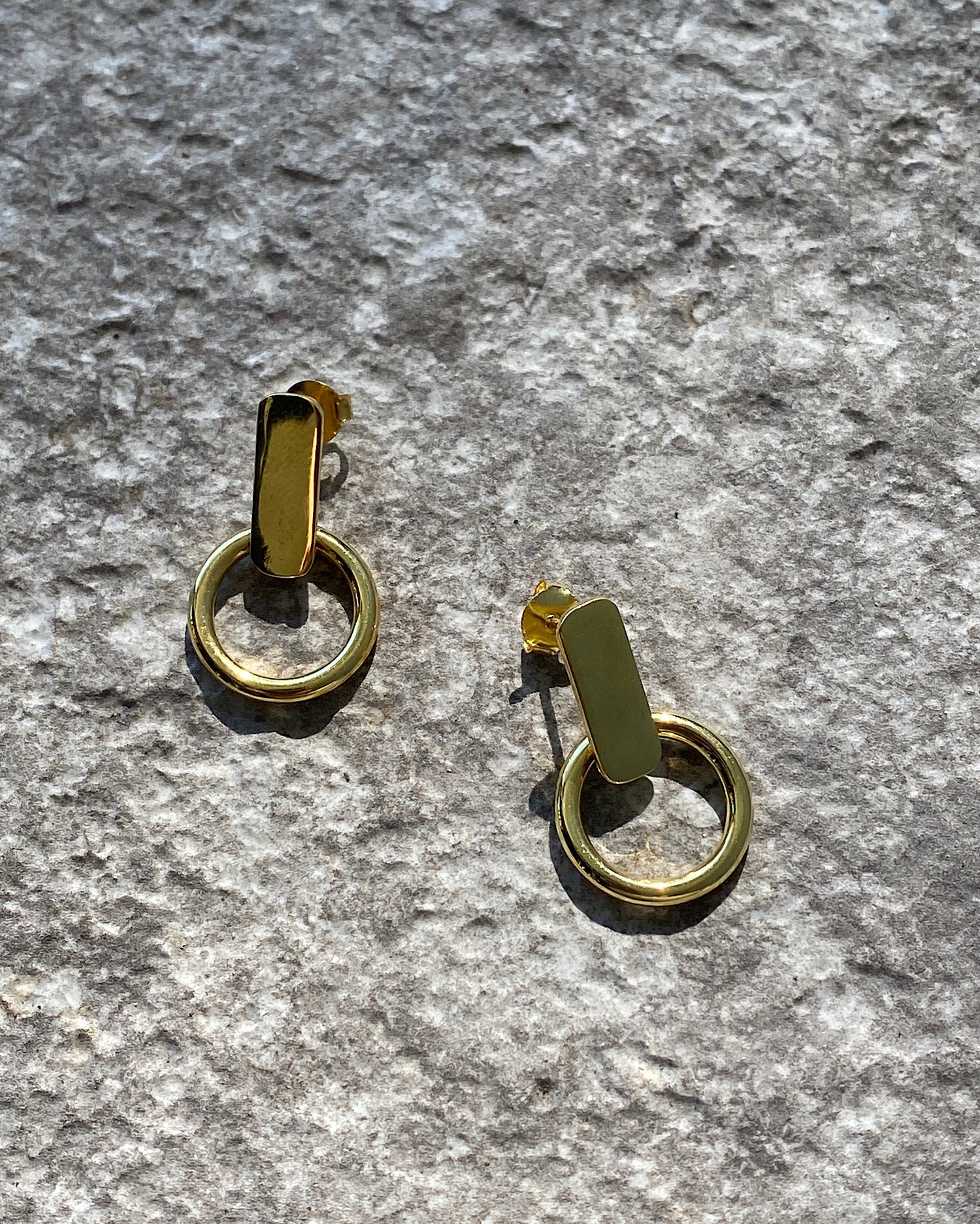 Gold rectangular studs with open hoops handing from them