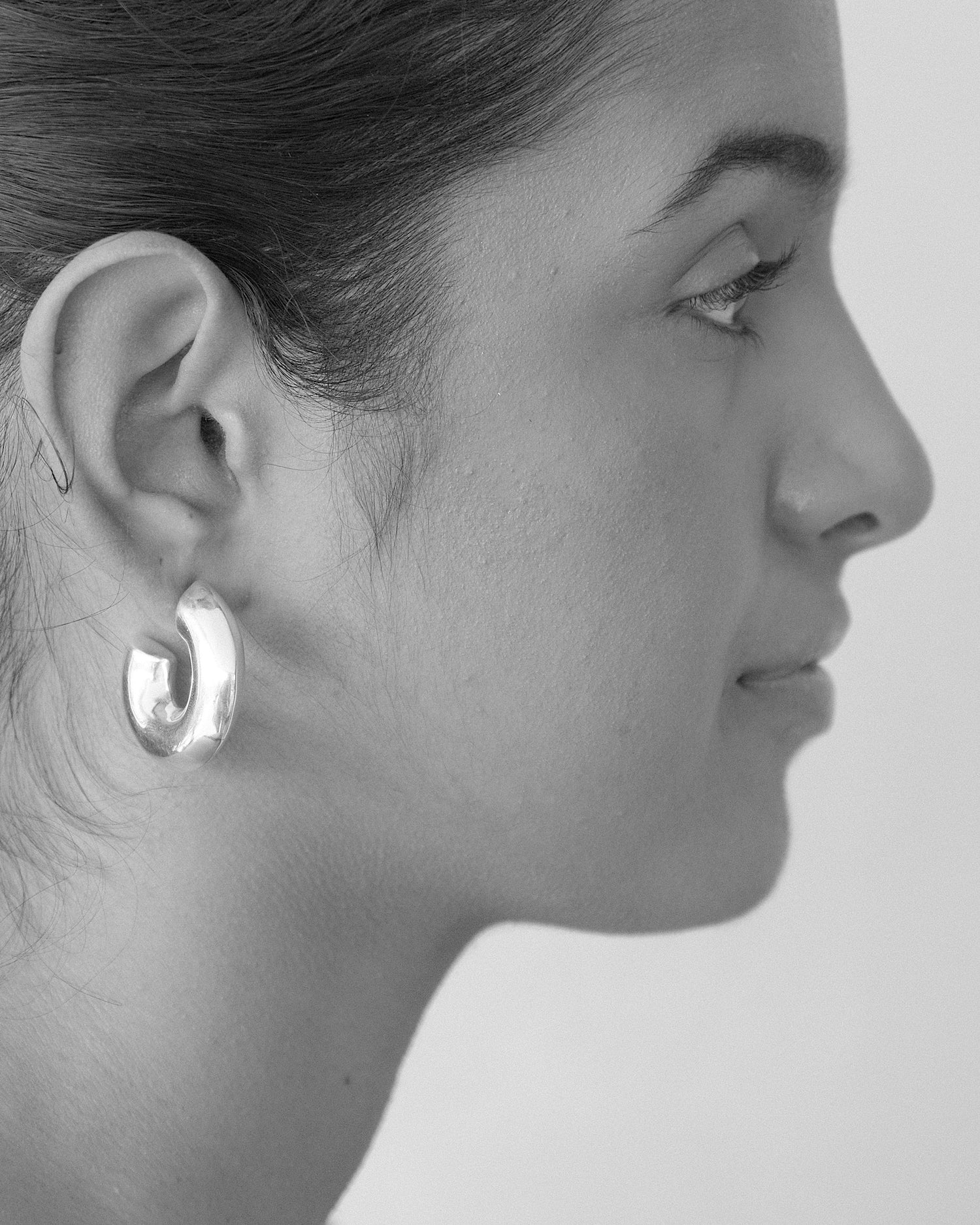 a model wears chubby hoop earrings