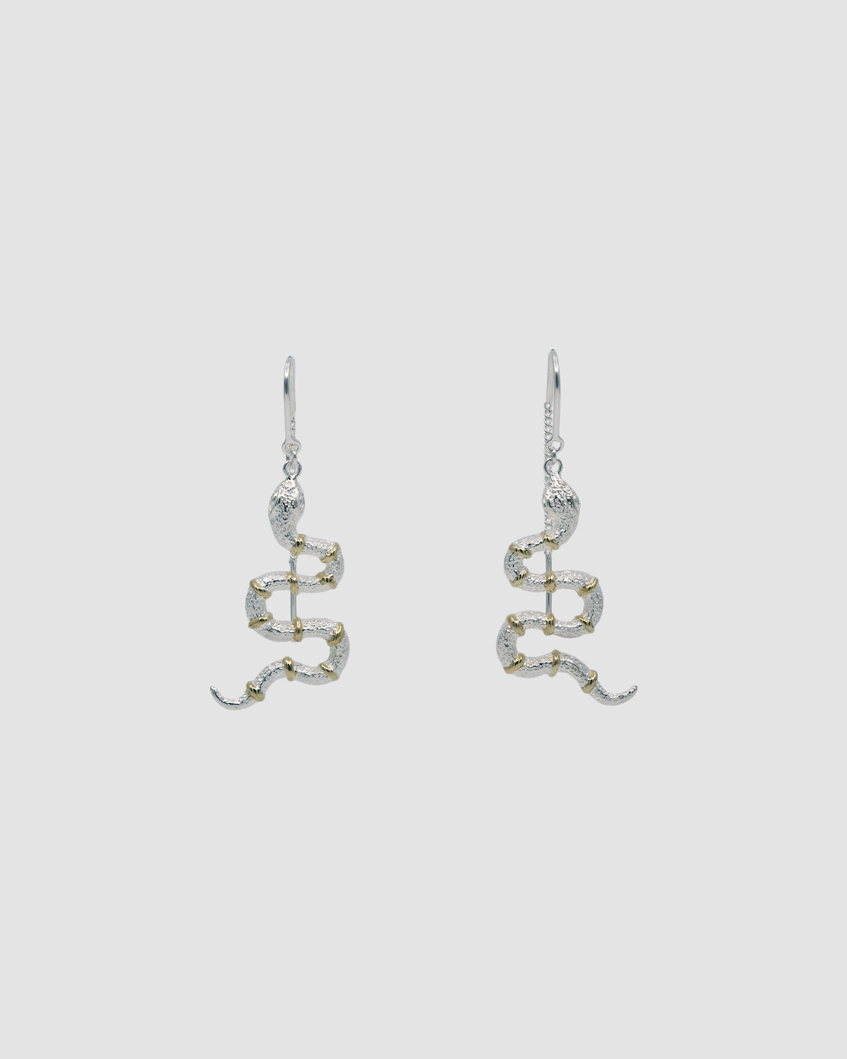 A pair of snake threaders earrings with gold band details