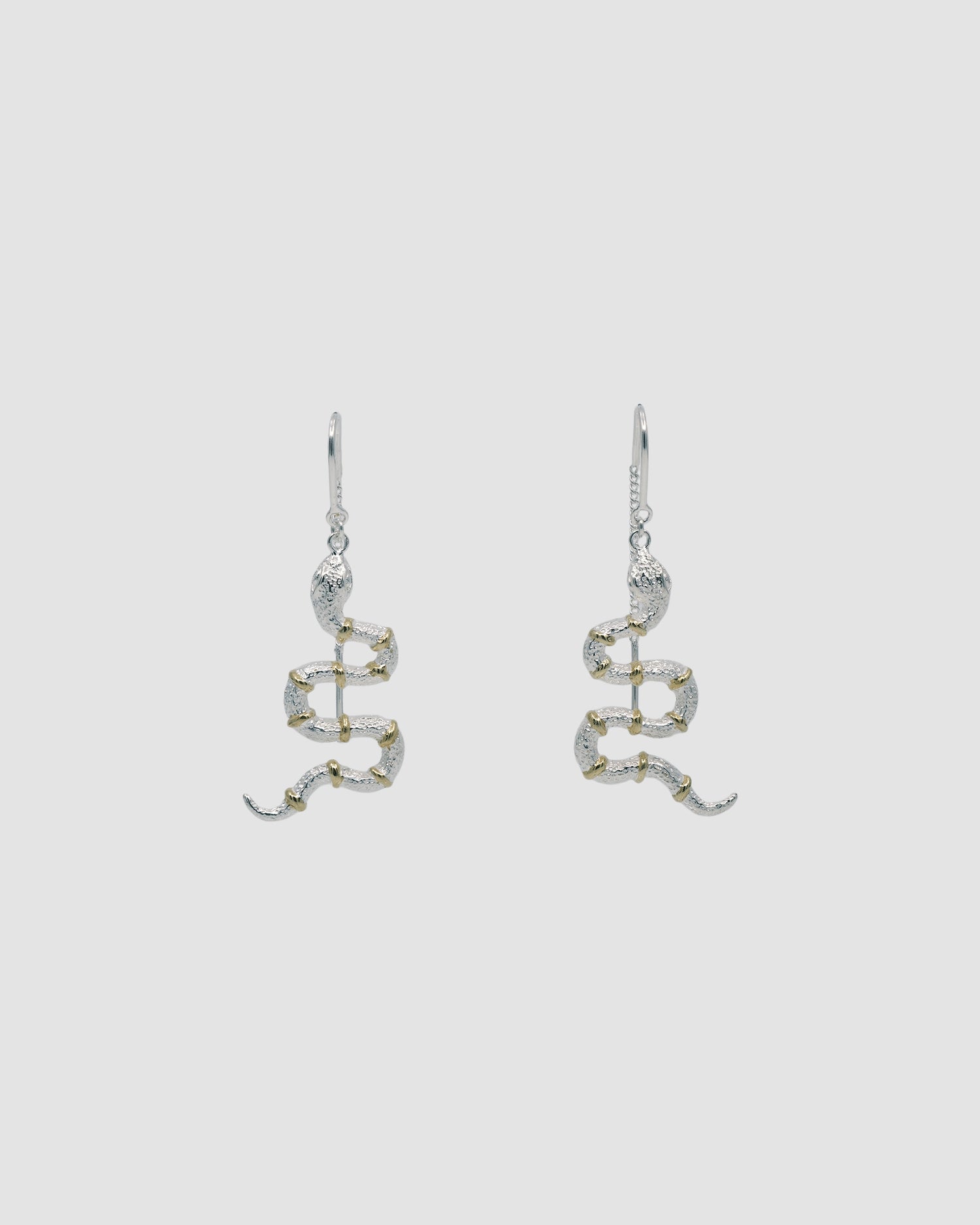 A pair of snake threaders earrings with gold band details