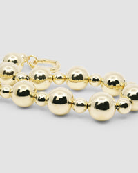 a large gold ball statement necklace