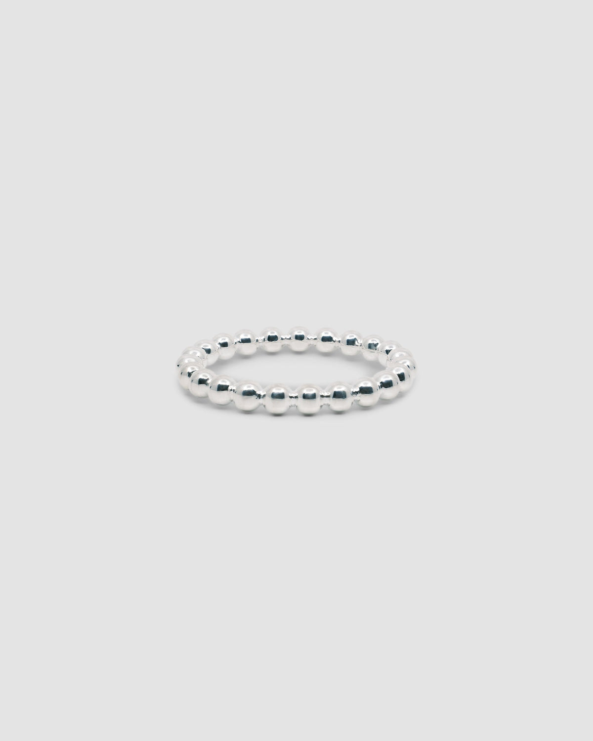 simple silver joined ball solid bracelet on grey background