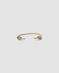 Gold open style bangle with two knots at the end