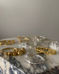 a group of silver and gold bracelets