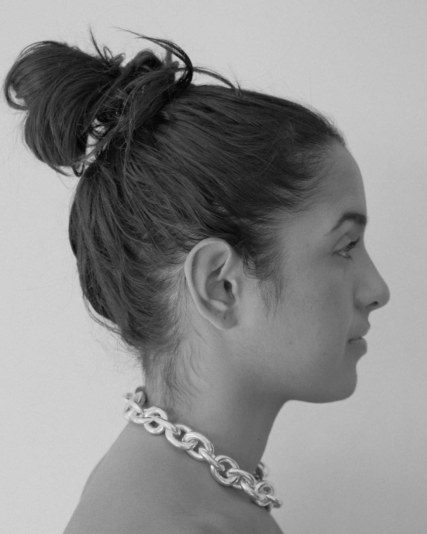 a chain necklace sits on a models neck