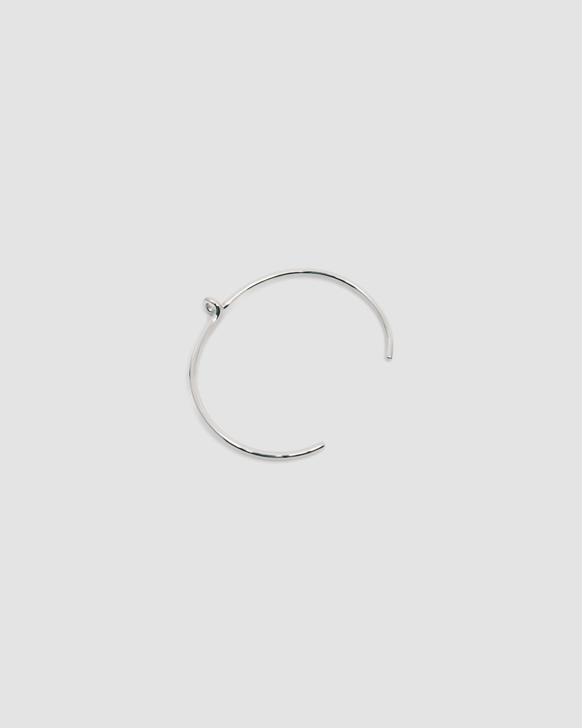 thin open silver cuff with a central loop