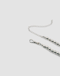 detail of a silver ball necklace showing the extended chain and clasp