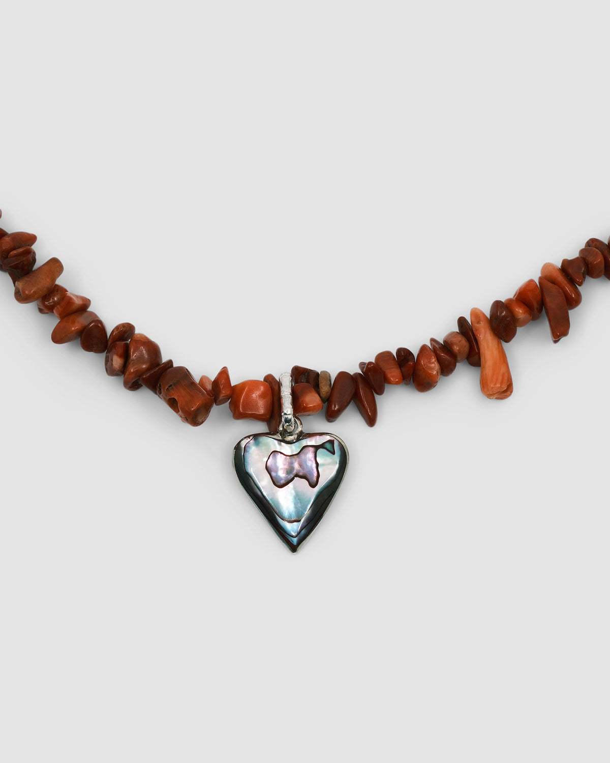 a red coral jagged necklace with a central abalone heart charm