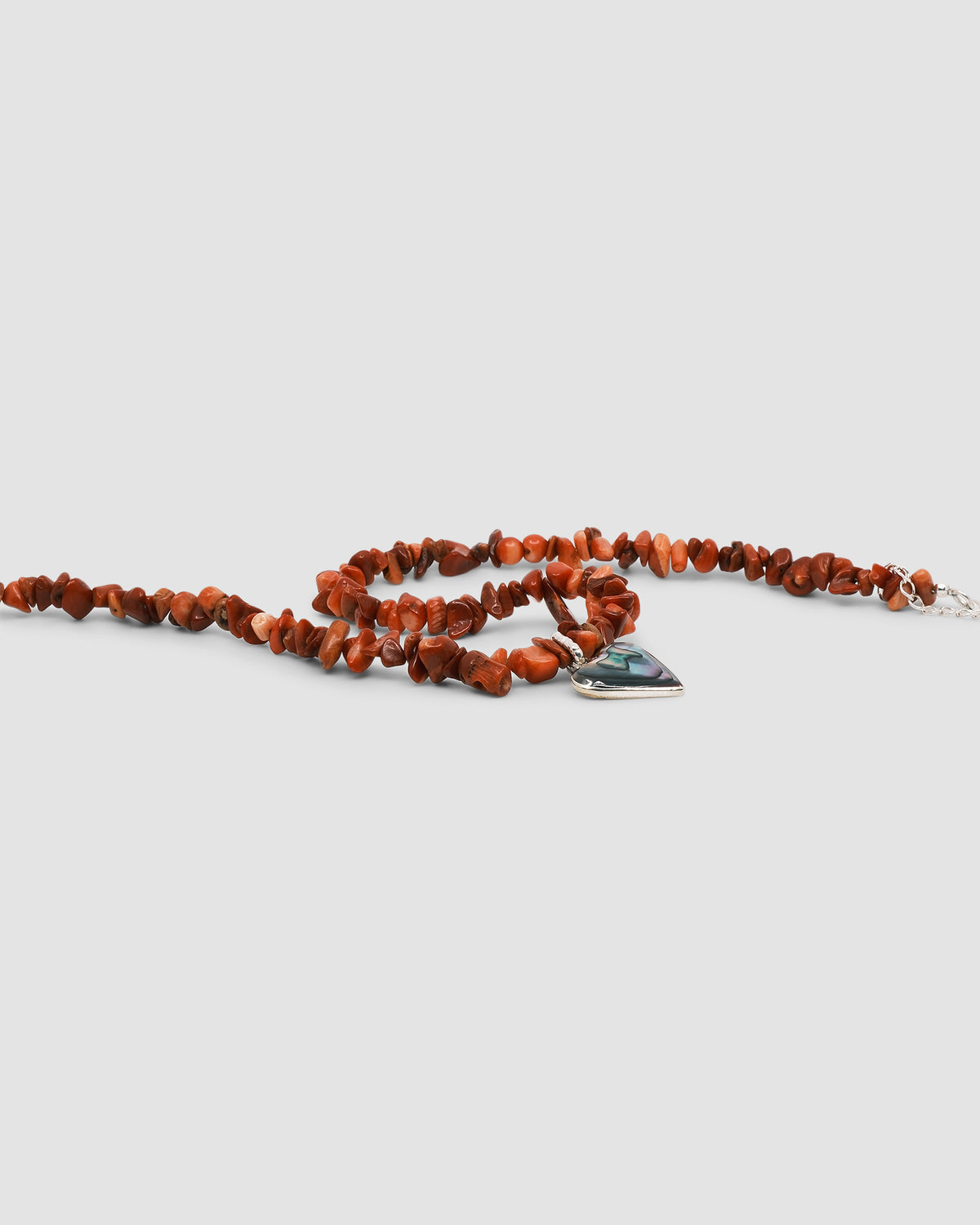 a red coral jagged necklace with a central abalone heart charm