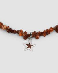 a red coral jagged necklace with a central coral and silver star