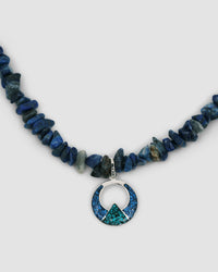 a blue stone jagged necklace with a central turquoise and silver open oval pendant