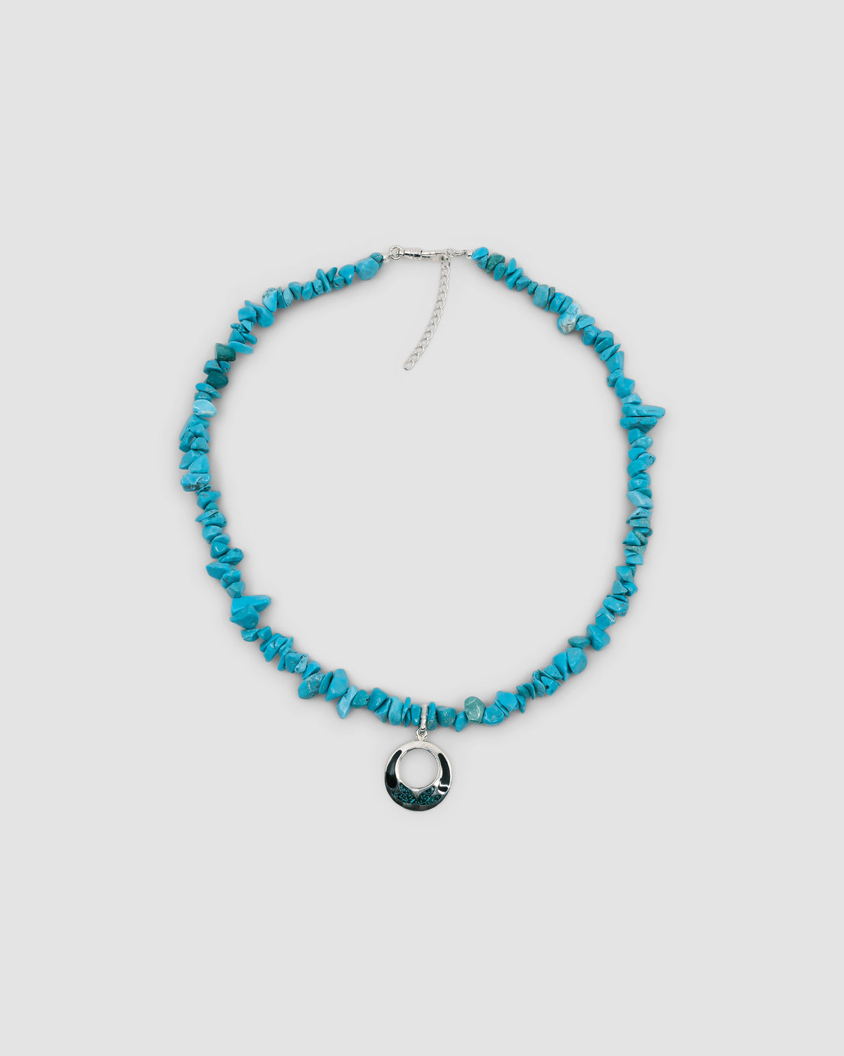 blue turquoise jagged stone necklace with an open silver pendant featuring turquoise and black inlay