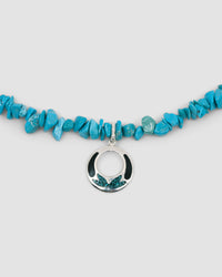 blue turquoise jagged stone necklace with an open silver pendant featuring turquoise and black inlay