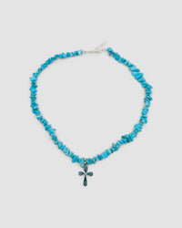 blue turquoise jagged stone necklace with a pendant featuring turquoise and silver cross