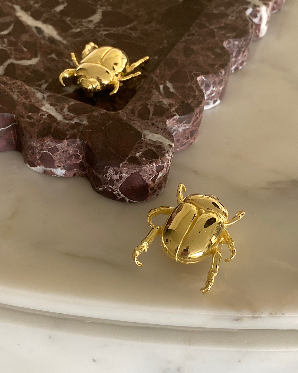 a gold christmas beetle brooch