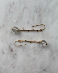 Long gold drop earrings with clear quartz