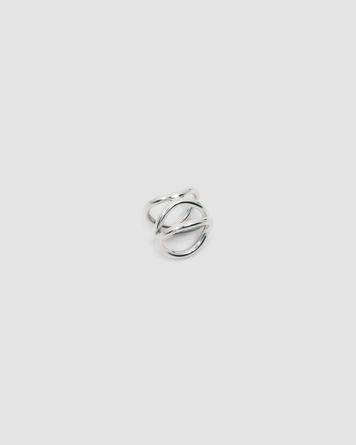 A silver ring made up of a several curved rings joined