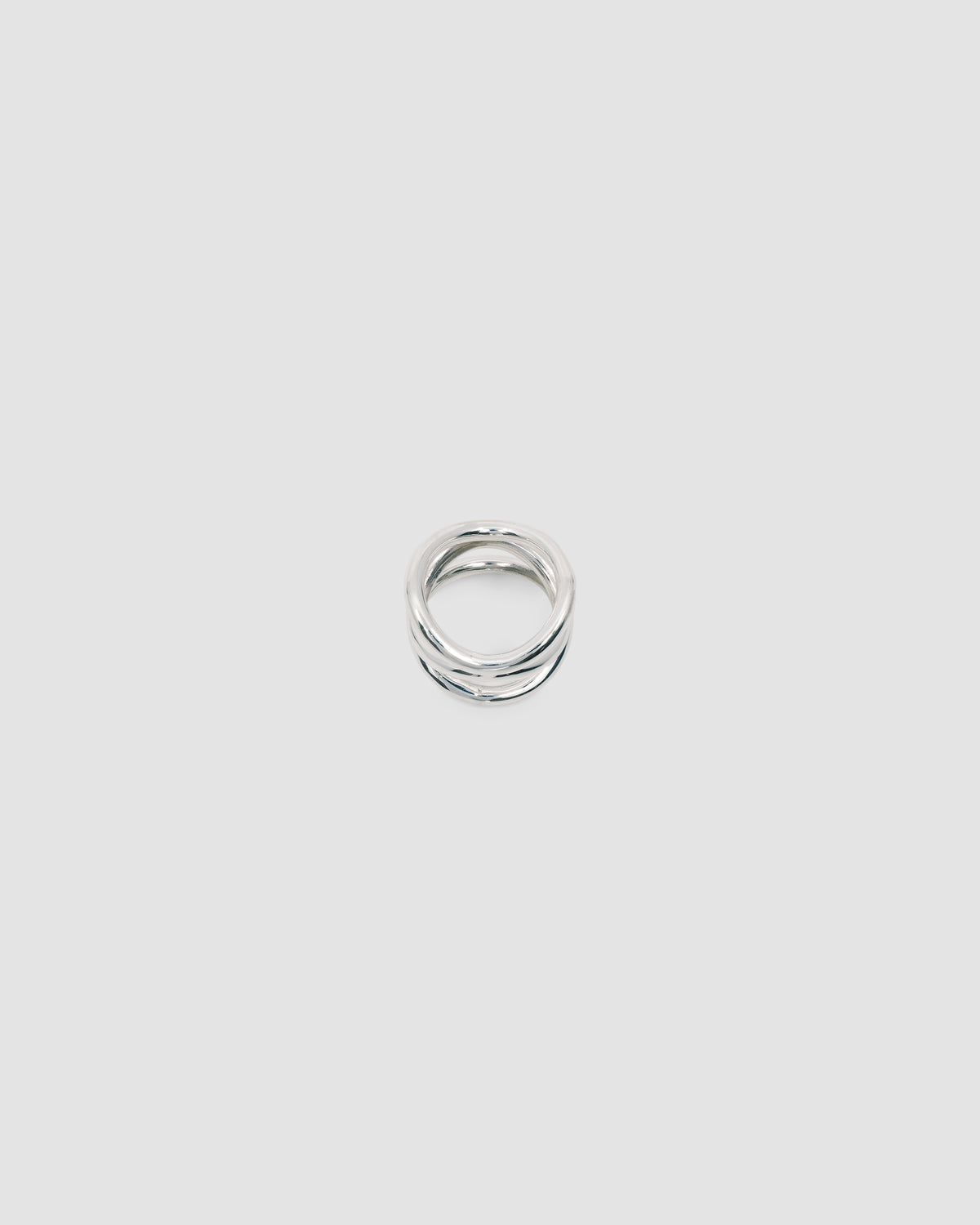 A silver ring made up of a several curved rings joined