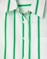 Close-up of a white shirt with green vertical stripes and buttons.
