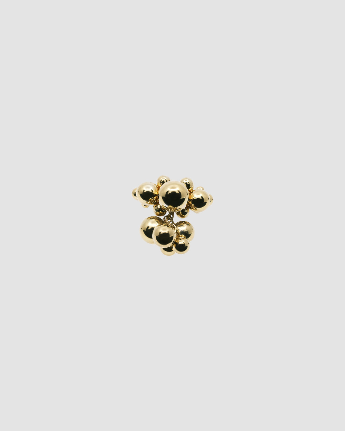 a gold bubble ring with a gold cluster hanging from it