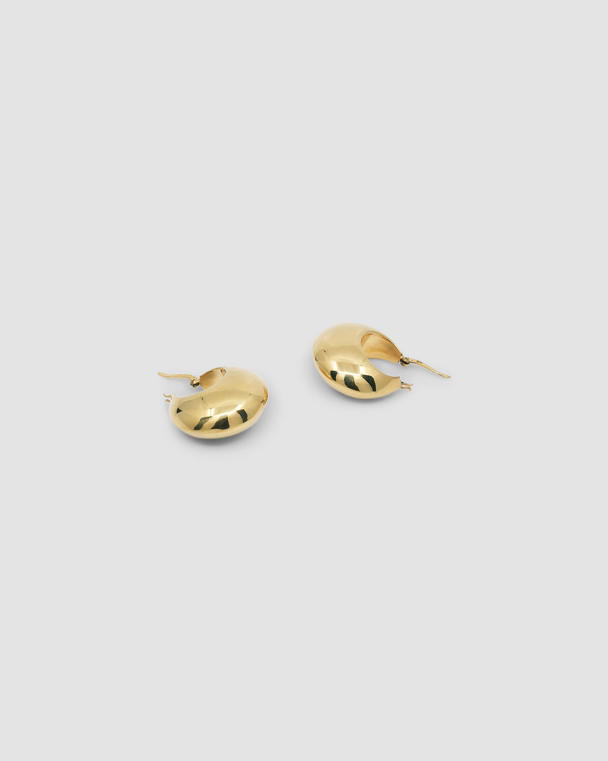 simple crescent shaped fat gold earring with a latch closure