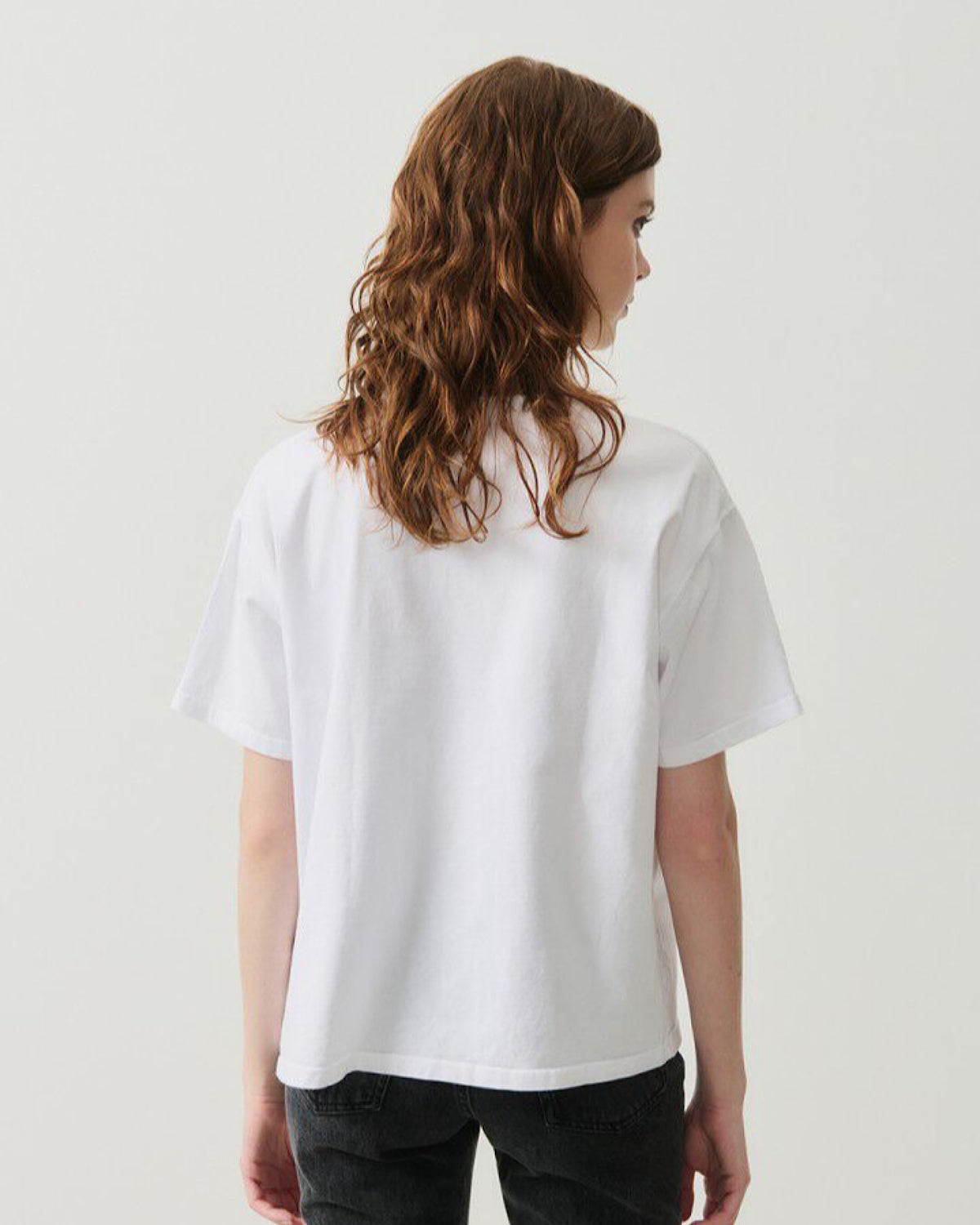 model wears a white tshirt and black Jeans