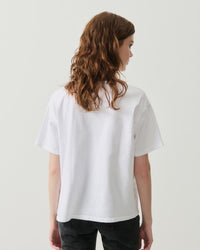 model wears a white tshirt and black Jeans
