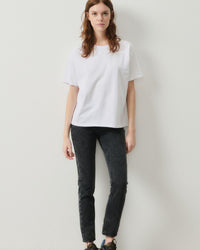 model wears a boxy white t with jeans