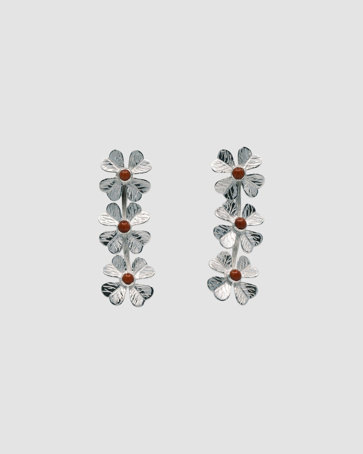 triple four leaf clover silver drop earrings featuring coral