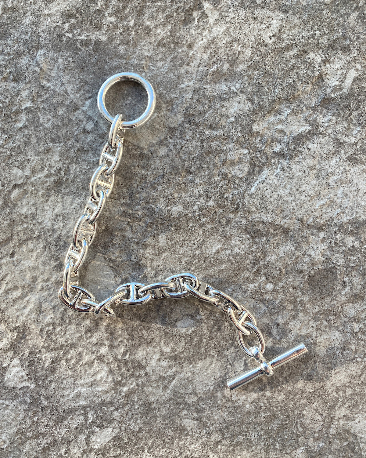 Silver chain bracelet with a fob ending