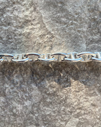 silver chain against concrete