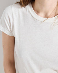 White t-shirt worn by a person on a neutral background