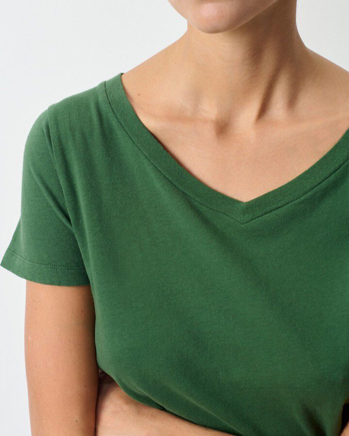 closeup of a model wearing a green short sleeve v tee