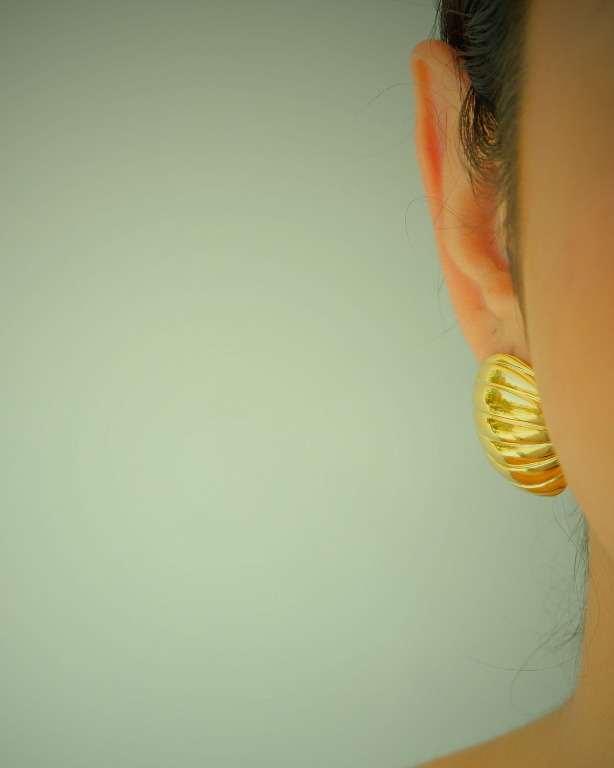 model wears gold glenn earrings