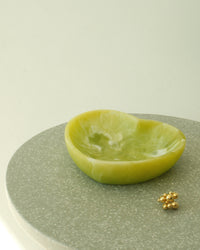 bubble cluster gold ring sits on a table next to a green heart bowl